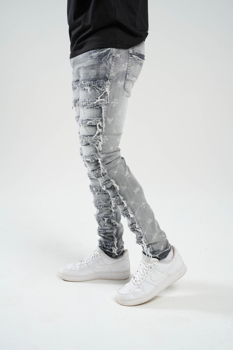 TAKER-PREMIUM STRETCH SLIM FIT JEANS WITH DISCHARGE PRINT & FRAYED PATCH